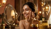 Young woman applying face cream in luxurious bathroom with golden lighting and vintage mirror for skincare routine and beauty care concept.