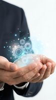 Businessman hands holding glowing digital gears and technology icons representing innovation, automation and business solutions for modern industry.