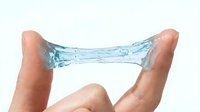 Water droplet stretching between two fingers, demonstrating surface tension and liquid elasticity. Isolated on white background, suitable for science education, skincare, hydration, and wellness design projects.
