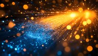 Abstract golden light rays bursting through blue glowing particles, creating dramatic contrast with bokeh effect on dark background.