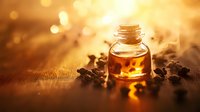 Small glass bottle with aromatic essential oil surrounded by coffee beans on wooden surface, warm golden bokeh background creates magical atmosphere.