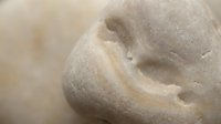 Close-up of creamy beige facial clay mask with smooth texture on skin. Skincare treatment for spa, beauty routine and natural cosmetics applications.