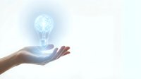 Hand holding glowing light bulb with brain inside representing innovation, creativity, and bright ideas for business solutions and inspiration.