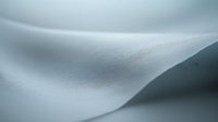Soft white paper texture with smooth flowing curves and subtle grain, creating an elegant minimalist background for design projects.