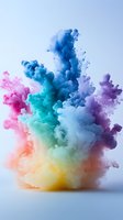Vibrant multicolored smoke explosion with pink, blue, turquoise, yellow and purple hues creating dynamic abstract formation against light background.