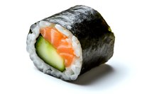 Fresh salmon and cucumber sushi roll with nori seaweed and white rice on white background, macro food photography for restaurant menu and delivery.