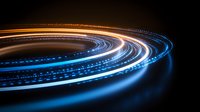 Glowing spiral light trails in blue and orange colors against dark background create dynamic motion effect for technology and communication designs.