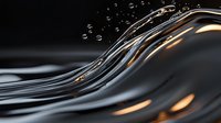 Elegant dark liquid wave with golden light reflections and floating water drops creates dynamic flowing motion against black background, suitable for luxury designs.