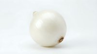 White onion with papery skin and dried root end isolated on neutral background, suitable for food, cooking, and culinary projects.