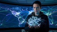 Man holding digital globe with network connections and world map, representing global technology, data connectivity, and international business communication.