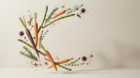 Fresh vegetables and herbs arranged in a crescent shape on a light background, featuring carrots, asparagus, rosemary, thyme, and star anise.