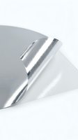 Shiny metallic silver foil paper with curved edges and reflective surface on white background for packaging and craft projects.