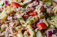 Creamy tuna pasta salad with penne, cherry tomatoes, red onions and fresh dill garnish, mixed in mayonnaise dressing for summer picnics and gatherings.