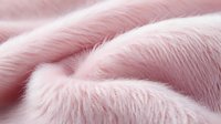 Soft pink faux fur texture background with gentle waves and folds creating luxurious plush surface, suitable for fashion, beauty and lifestyle designs.