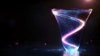Glowing spiral light trail swirls inside martini glass against dark background creating magical ethereal effect with luminous blue and purple colors.