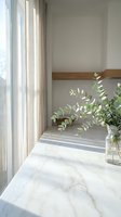 Minimalist marble windowsill with eucalyptus branches in glass vase near window with natural light and neutral curtains for home decor and interior design.