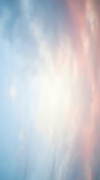 Soft gradient background transitioning from cool blue tones on the left to warm pink and peachy hues on the right, with ethereal white clouds and light diffusion throughout. Suitable for web design, presentations, and creative projects.