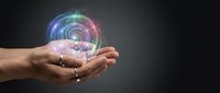 Male hands holding glowing colorful energy sphere with digital light effects on dark background for technology and innovation concepts.