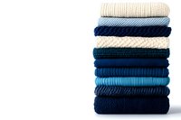 Stack of folded knitted sweaters in blue, teal, and cream tones isolated on white background, showcasing cozy winter fashion textures.