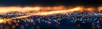 Abstract panoramic view of glowing bokeh lights creating a magical nighttime cityscape with warm orange and blue tones against dark background.