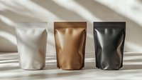 Three blank stand up pouches in white, bronze and black colors with natural window light and shadow on beige background, mockup for product packaging design.