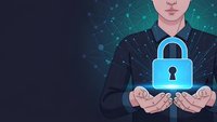 Professional businessman holding glowing blue padlock symbol representing cybersecurity and data protection in digital network environment.