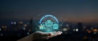 Hand holding glowing neon hologram of delivery truck with "we are serving you" text above cityscape at night for logistics and customer service concepts.