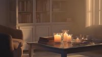 Cozy living room interior with warm candlelight creating romantic ambiance on wooden coffee table, soft armchair and elegant paneled walls in evening.