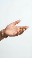 Open cupped hands gesture showing palm and fingers in receiving position with gold jewelry and bracelet on neutral background for presentation concepts.