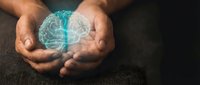 Hands holding glowing digital brain hologram representing artificial intelligence, mental health, neuroscience and innovative technology concepts.