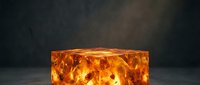 Glowing amber crystal cube with internal fire patterns on dark background for luxury product display and premium branding materials.