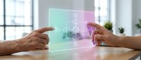 Business partnership concept with hands connecting holographic puzzle pieces on modern office desk representing teamwork and collaboration solutions.