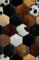 Hexagonal patchwork pattern with animal fur textures in brown, black and white tones. Seamless geometric design for textile and interior decoration.