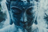 Serene Buddha statue head in ethereal blue tones surrounded by mystical smoke, creating spiritual atmosphere for meditation and mindfulness practices.
