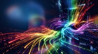 Abstract rainbow light trails flowing in dynamic waves with glowing particles and energy beams creating futuristic digital art background for technology concepts.