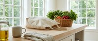 Fresh vegetables in wicker basket on kitchen counter with natural light from windows. Healthy cooking ingredients for meal preparation and organic food.