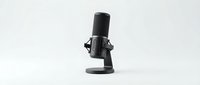 Professional studio microphone with shock mount isolated on white background, ready for podcast, music recording, streaming, and audio production design projects.