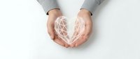 Hands cupping glowing geometric heart shape with network connections, symbolizing love, care, protection and digital wellness concepts.