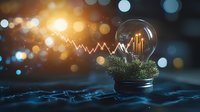 Glowing light bulb with growing financial chart and plant inside on keyboard background with bokeh lights, symbolizing sustainable business growth.