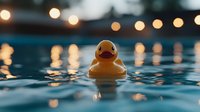 Yellow rubber duck floating in water with blurred bokeh lights creating magical evening atmosphere, reflections rippling on dark blue surface.