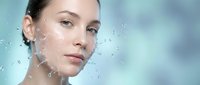 Young woman with water droplets on face showcasing fresh clean skin and natural beauty for skincare and wellness concepts.