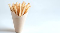 Golden crispy french fries in kraft paper cone against white background, isolated. Fast food snack for restaurant menu, food delivery service and takeaway design.
