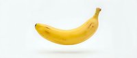 Single ripe yellow banana isolated on white background, ready for design use, food packaging, and culinary projects.