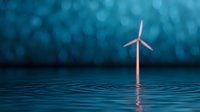 Wind turbine in water with ripples against blurred blue bokeh background, representing renewable energy and sustainable power generation.