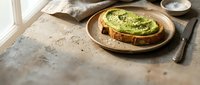 Avocado toast on rustic wooden plate with natural lighting, healthy breakfast meal on textured table surface for food photography and culinary content.