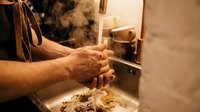 Senior male hands washing with soap at kitchen sink after cooking, emphasizing hygiene and cleanliness in food preparation for healthy lifestyle.