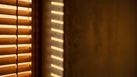 Warm sunlight streaming through wooden window blinds creating striped shadow patterns on textured wall interior design element for home decor projects.