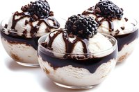 Vanilla ice cream dessert with chocolate sauce and fresh blackberries in glass bowls on white background, isolated for culinary design projects.