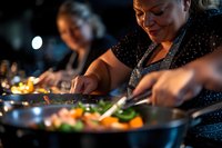 Caucasian female chef preparing fresh ingredients in restaurant kitchen, focused on chopping vegetables with professional knife skills in warm lighting.