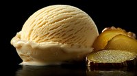 Creamy vanilla ice cream scoop with rich texture and swirls alongside sliced fresh passion fruit on dark background with dramatic lighting and reflective surface.
